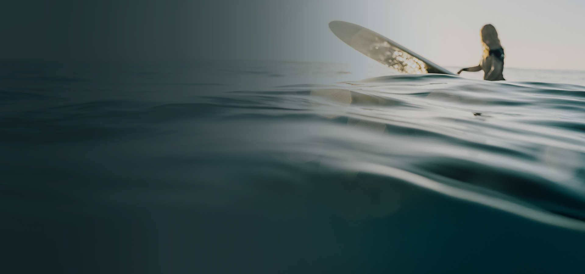 Australian surfer in ocean representing EVT Marketing's long-standing local incentive agency story