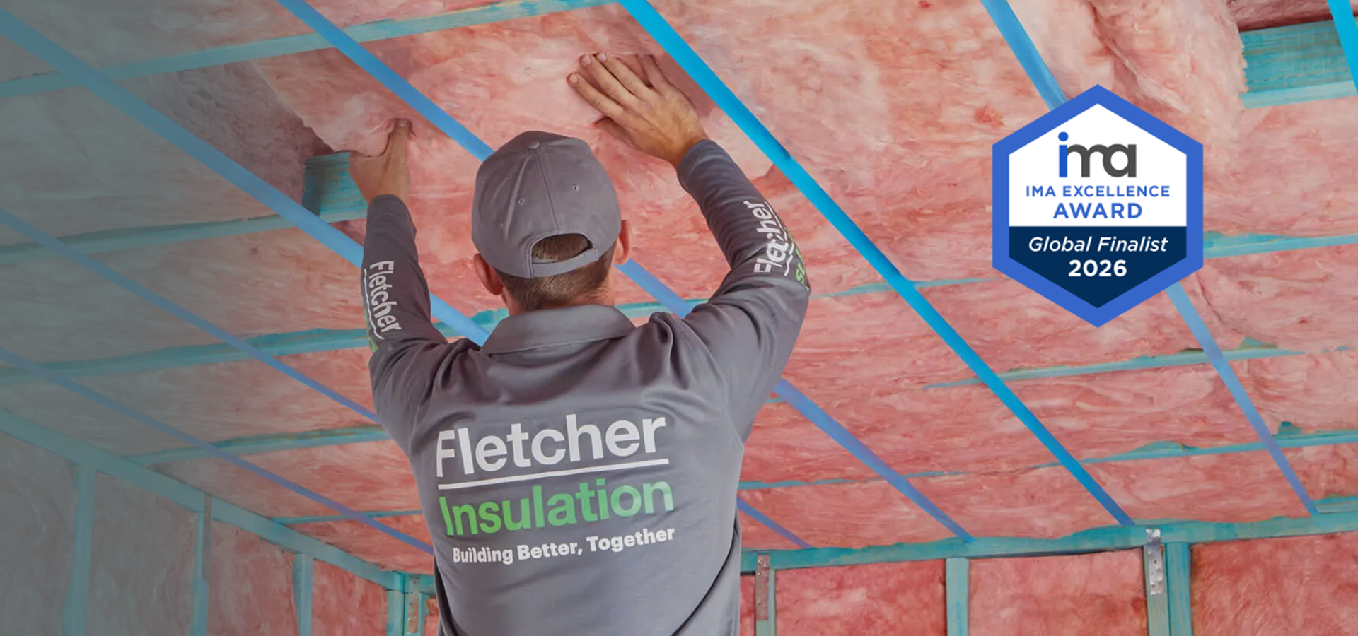 Fletcher Insulation installer fitting ceiling insulation with an IMA Excellence Award Global Finalist 2026 badge.